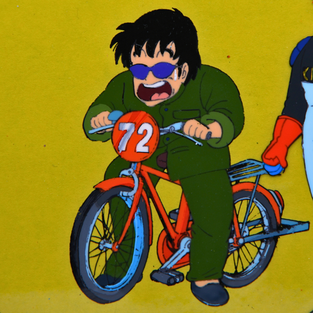 Close-up of Tsukutsun Tsun on bicycle in original Dr. Slump production cel