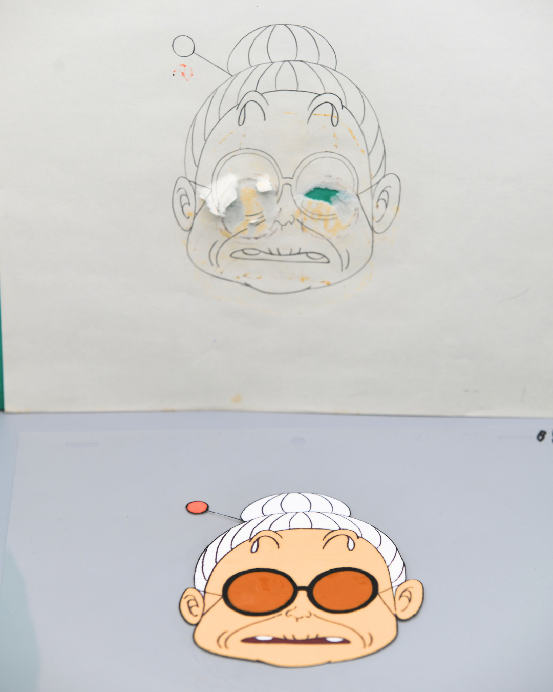 Oma matching production douga and floating head cel from Dr. Slump